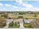 Beautiful aerial view of a home and community, showing a sprawling green lawn and golf course at 25073 Riverwalk Dr, Leesburg, FL 34748