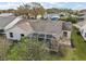 Aerial view of the backyard with a screened-in patio, perfect for outdoor entertaining and relaxation at 25073 Riverwalk Dr, Leesburg, FL 34748