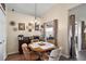 Cozy dining area with wood table, chandelier, and sliding door access to the outdoors at 25073 Riverwalk Dr, Leesburg, FL 34748