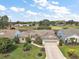 Aerial view of the home showcasing its well-manicured lawn and proximity to the golf course at 25073 Riverwalk Dr, Leesburg, FL 34748