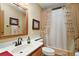 Bathroom with a mirror above the sink, shower and patterned curtain at 25605 Belle Alliance, Leesburg, FL 34748