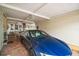 View of a covered carport area, paved with brick and featuring a parked car and some outdoor furniture at 25605 Belle Alliance, Leesburg, FL 34748