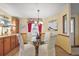 Dining area with a round glass table, four chairs, and built-in cabinets at 25605 Belle Alliance, Leesburg, FL 34748