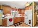 Well-lit kitchen showcasing wood cabinets, white counters, a brick-style backsplash, and updated appliances at 25605 Belle Alliance, Leesburg, FL 34748