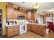 Functional kitchen with white countertops, stainless steel microwave and a breakfast bar with red chairs at 25605 Belle Alliance, Leesburg, FL 34748