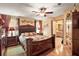 Comfortable main bedroom features a decorative headboard, wood furnishings, and ensuite bath access at 25605 Belle Alliance, Leesburg, FL 34748