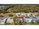 Aerial view of the home, in a lush neighborhood with mature trees and native landscaping at 26148 Glen Eagle Dr, Leesburg, FL 34748