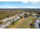 Community aerial view showcasing golf course, ponds and mature Florida landscaping in a sunny environment at 26148 Glen Eagle Dr, Leesburg, FL 34748