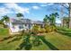 Backyard view showcasing the lush lawn and mature landscaping at 26148 Glen Eagle Dr, Leesburg, FL 34748