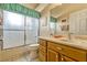 Bathroom featuring a vanity with drawers and a shower-tub combination at 26148 Glen Eagle Dr, Leesburg, FL 34748