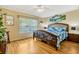 Cozy bedroom with hardwood floors and a comfortable bed at 26148 Glen Eagle Dr, Leesburg, FL 34748