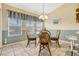 Bright breakfast nook with a glass table, rattan chairs, and ample natural light at 26148 Glen Eagle Dr, Leesburg, FL 34748