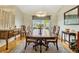 Formal dining room featuring hardwood floors, a large window and sophisticated traditional furnishings at 26148 Glen Eagle Dr, Leesburg, FL 34748