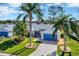 Aerial of home showcasing lovely landscaping, brick driveway, and bright blue garage door at 26148 Glen Eagle Dr, Leesburg, FL 34748