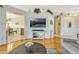 Bright living room featuring hardwood floors, a decorative shelf, and an open layout to the breakfast nook at 26148 Glen Eagle Dr, Leesburg, FL 34748