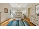 Serene main bedroom with hardwood floors, a ceiling fan, and an ensuite bathroom at 26148 Glen Eagle Dr, Leesburg, FL 34748