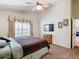 Comfortable bedroom featuring carpeted floors, ceiling fan, and a large window providing natural light at 2917 White Cedar Cir, Kissimmee, FL 34741