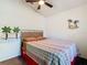 Neutral bedroom with a ceiling fan, a comfy bed and decorative palm tree accents on the wall at 2917 White Cedar Cir, Kissimmee, FL 34741