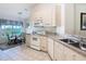 Kitchen flows into the breakfast nook, with a sunlit window and pendant lighting at 2917 White Cedar Cir, Kissimmee, FL 34741