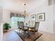 Bright dining area with tile flooring, decorative chandelier and large window at 2917 White Cedar Cir, Kissimmee, FL 34741