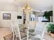 Dining area with tile floors, a chandelier, and an open view of the living room at 2917 White Cedar Cir, Kissimmee, FL 34741