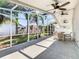 Enclosed patio showcases beautiful landscaping, with seating, and ceiling fans at 2917 White Cedar Cir, Kissimmee, FL 34741