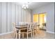 Bright dining room featuring a wooden table with white chairs and sliding glass door access to the patio at 2959 Banana Palm Dr, Kissimmee, FL 34747