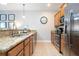 Galley-style kitchen with granite counters and stainless steel appliances at 2959 Banana Palm Dr, Kissimmee, FL 34747