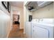 Hallway view of laundry closet with washer, dryer and overhead storage at 2959 Banana Palm Dr, Kissimmee, FL 34747