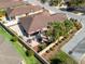 A captivating aerial view of the home, surrounded by lush greenery and a cozy backyard patio seating area at 3172 Amberly Ct, The Villages, FL 32163