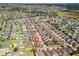 Stunning aerial view of a residential neighborhood showcasing single-Gathering homes with well-manicured lawns and mature trees at 3172 Amberly Ct, The Villages, FL 32163