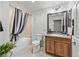 Bathroom featuring a tiled shower and tub combination and wooden vanity at 3172 Amberly Ct, The Villages, FL 32163