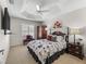 Bedroom featuring tray ceilings and a charming four-poster bed with stylish accents at 3172 Amberly Ct, The Villages, FL 32163