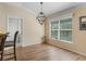 Dining area with decorative light fixture, large window, and wood-look tile flooring at 3172 Amberly Ct, The Villages, FL 32163