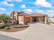 Inviting single-story home with an attached garage, beautiful landscaping and a welcoming front porch at 3172 Amberly Ct, The Villages, FL 32163