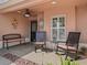 Comfortable front porch with seating, decor, ceiling fan, and view of the entrance at 3172 Amberly Ct, The Villages, FL 32163