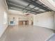 Large garage featuring painted floor, workbench, shelving, storage cabinets, and utility sink at 3172 Amberly Ct, The Villages, FL 32163