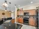 Kitchen features stainless steel appliances, wooden cabinets, and granite countertops at 3172 Amberly Ct, The Villages, FL 32163