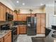 Kitchen featuring stainless steel appliances, wooden cabinets, and granite countertops at 3172 Amberly Ct, The Villages, FL 32163