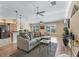 Bright living room features a comfortable sofa, ceiling fan and wood-style flooring at 3172 Amberly Ct, The Villages, FL 32163