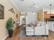 Inviting living room with modern decor, crown molding and neutral color palette at 3172 Amberly Ct, The Villages, FL 32163