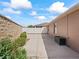 Backyard patio area with minimal shrubbery along the wall and flooring at 3172 Amberly Ct, The Villages, FL 32163