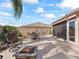 Expansive outdoor patio with room for seating, with a firepit and beautiful landscaping at 3172 Amberly Ct, The Villages, FL 32163