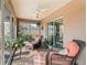 Relaxing sunroom with comfortable seating and view of the outdoor garden and block wall at 3172 Amberly Ct, The Villages, FL 32163