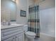 Well-maintained bathroom featuring a vanity, toilet, and a shower/tub with curtain at 320 Bentwood Dr, Leesburg, FL 34748