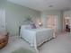 Spacious bedroom featuring a comfortable bed, neutral decor, and access to the Primary bathroom at 320 Bentwood Dr, Leesburg, FL 34748