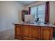 A cozy bedroom featuring a large wooden desk with a computer setup and bright natural light at 320 Bentwood Dr, Leesburg, FL 34748