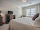 Cozy bedroom with striped accent wall, comfortable furnishings, and lots of natural light at 320 Bentwood Dr, Leesburg, FL 34748