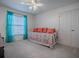 Bedroom featuring a daybed with bright pillows, double door closet and neutral carpeting at 320 Bentwood Dr, Leesburg, FL 34748