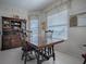 Bright dining area with a wooden table and chairs, a hutch, and natural light from a window at 320 Bentwood Dr, Leesburg, FL 34748